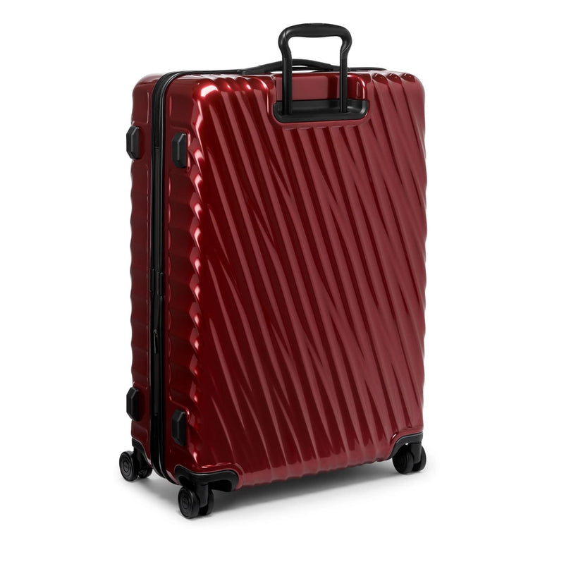 Red TUMI suitcase with black handle and wheels on a white background