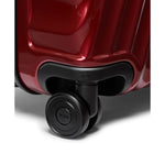 Close-up of a red TUMI suitcase wheel on a white background