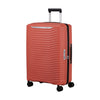 Red Samsonite suitcase with a textured surface on a white background