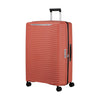 Clay Samsonite suitcase with a wavy texture on a white background