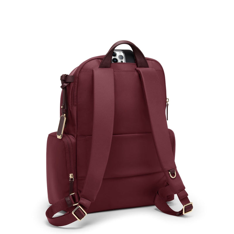 Wine TUMI backpack with gold accents on a white background