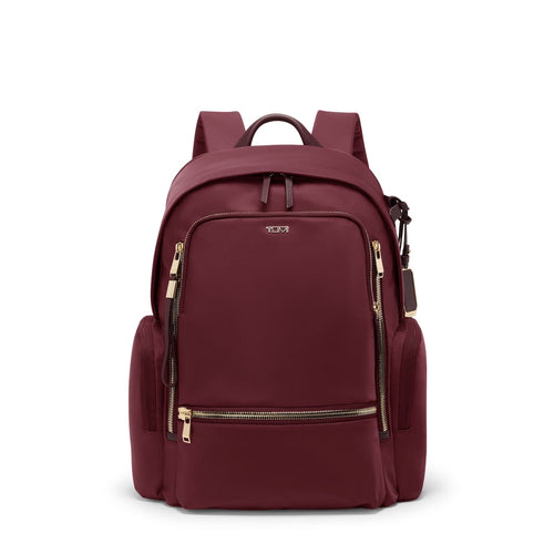 Wine TUMI backpack with gold zippers on a white background