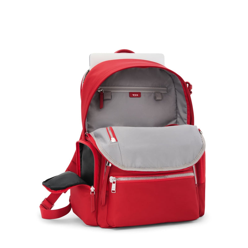 Red TUMI backpack with gray interior on a white background