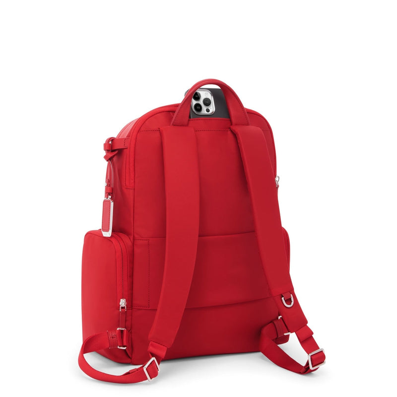 Red TUMI backpack with straps and a small pouch on a white background