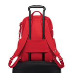 Red TUMI backpack on a white background