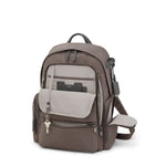 Mink TUMI backpack with multiple pockets and a key attached on a white background