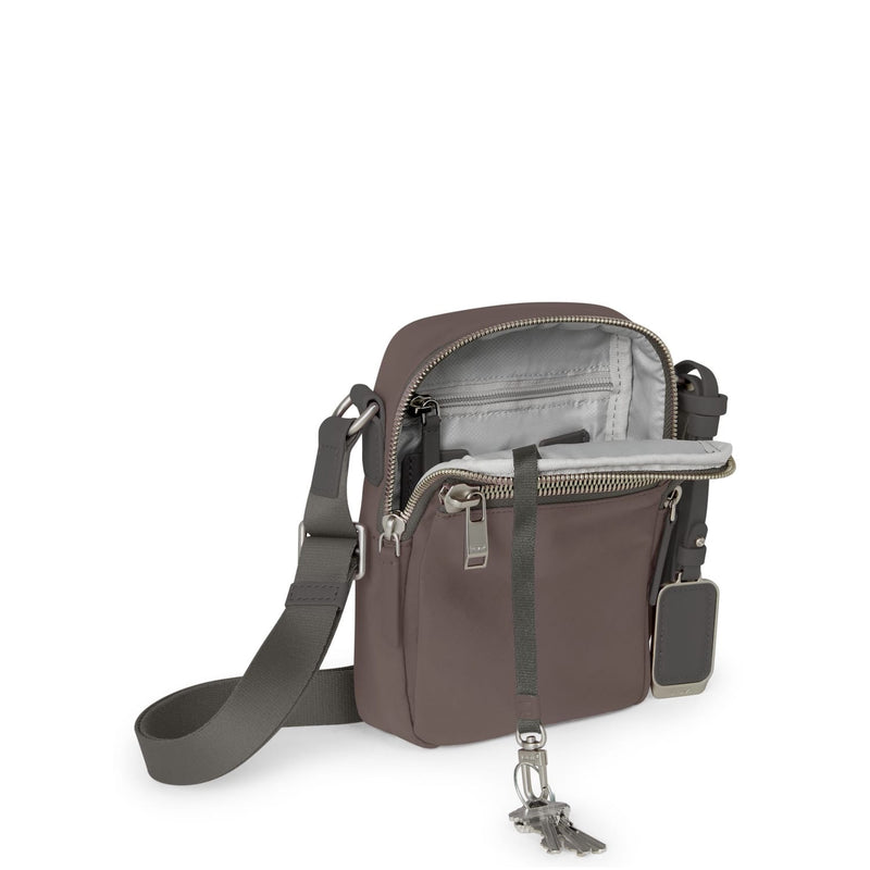 Mink TUMI crossbody bag with gray strap on a white background