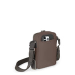 Mink TUMI crossbody bag with a phone pocket on a white background