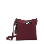 Wine TUMI crossbody bag with a phone pocket on a white background