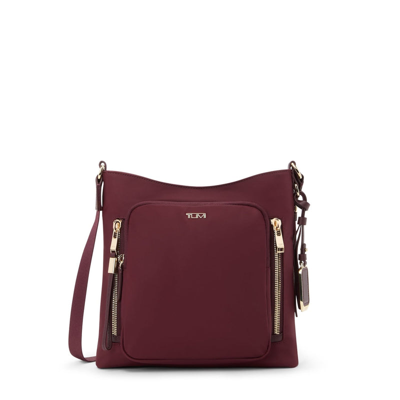 Wine TUMI handbag with gold zippers on a white background