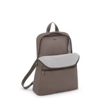 Mink TUMI backpack with a front pocket on a white background