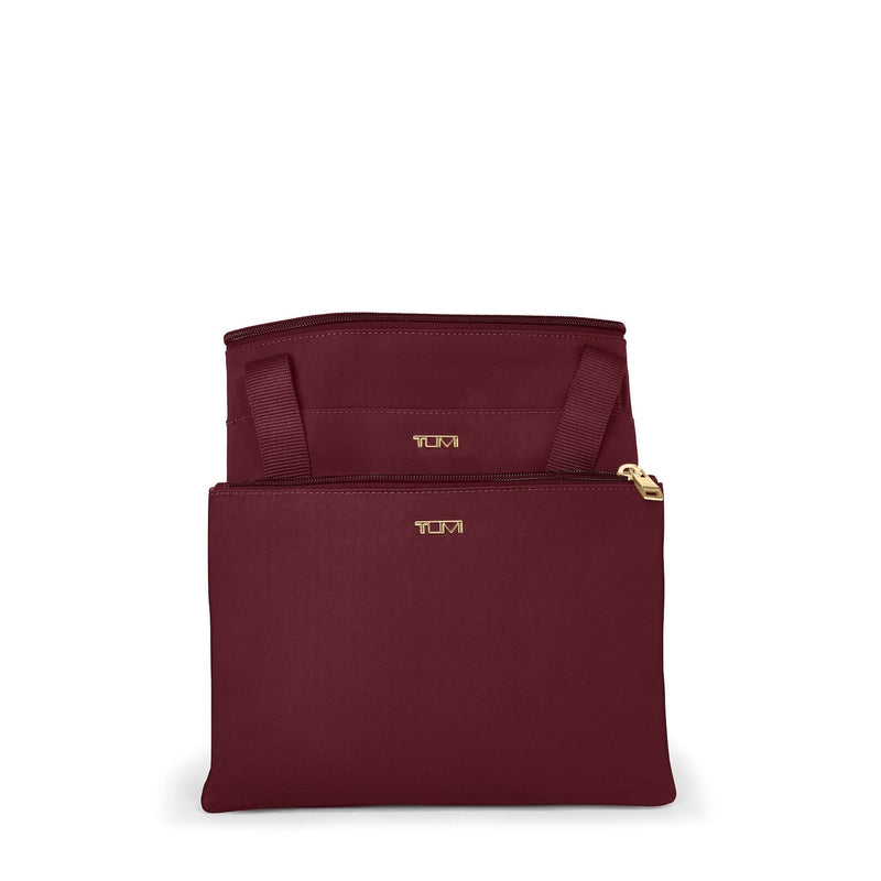 Wine TUMI pouch with gold zipper and logo on a white background