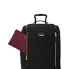 Black TUMI suitcase with gold accents and a matching maroon pouch on a white background