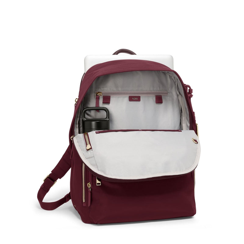 Maroon TUMI backpack with white interior on a white background