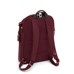 Maroon TUMI backpack with gold zippers on a white background
