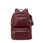 Maroon TUMI backpack with gold zippers on a white background