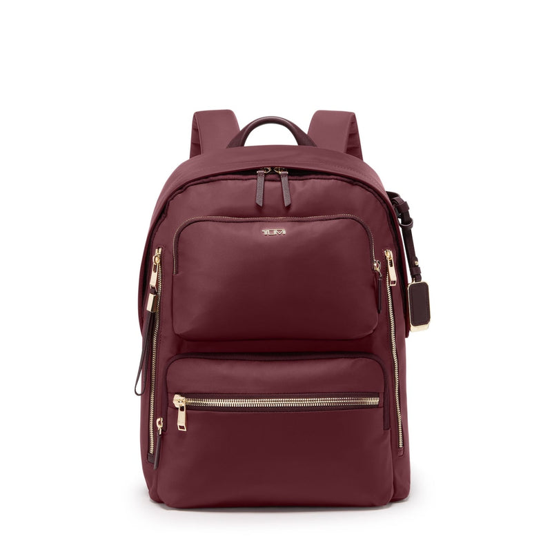 Maroon TUMI backpack with gold zippers on a white background