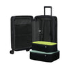 Black Samsonite suitcase with green and blue packing cubes on a white background