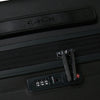 Black Samsonite suitcase with a combination lock on a dark background