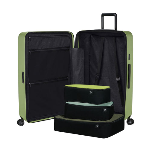 Green Samsonite suitcase with open lid showing black interior and a step stool inside.