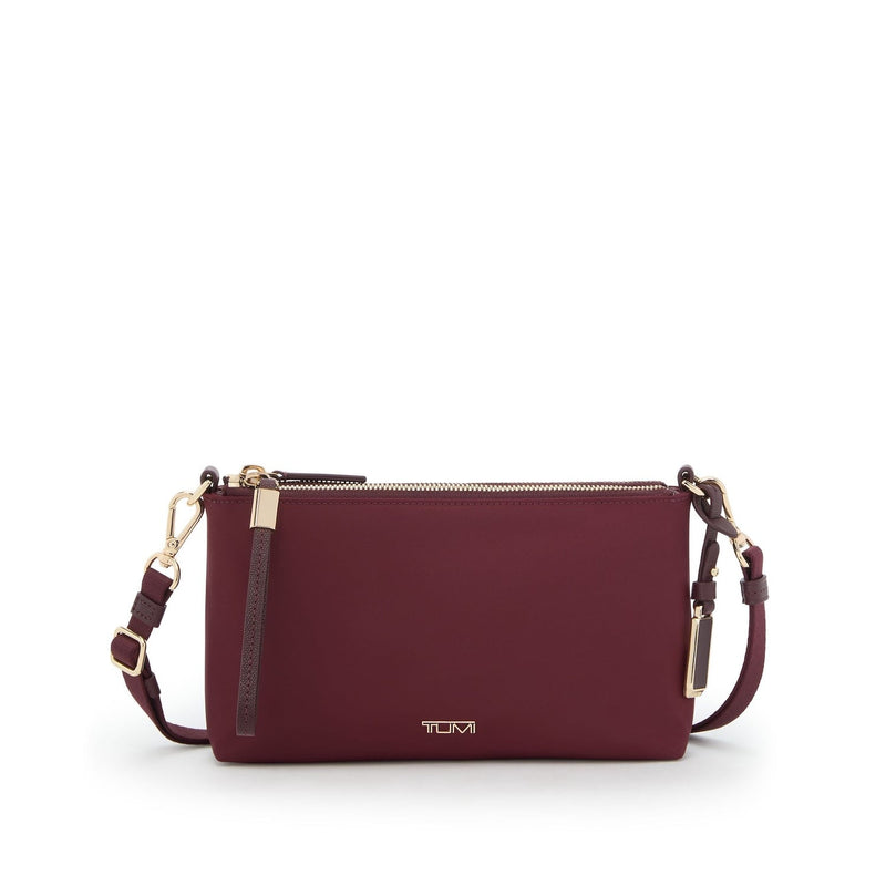 Wine TUMI handbag with gold accents on a white background