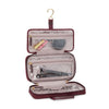 TUMI Travel toiletry bag with clear compartments on a white background