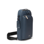 Blue TUMI shoulder bag with a strap on a white background
