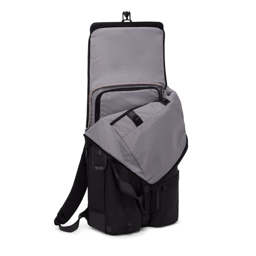 Black TUMI backpack with open front compartment on a white background