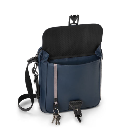 Navy blue TUMI bag with black interior on a white background