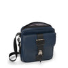 Navy blue TUMI crossbody bag with black strap on a white background