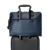Blue TUMI briefcase with black handle on a white background