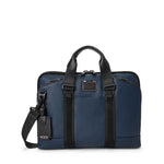 Blue TUMI briefcase with black straps on a white background
