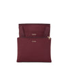maroon TUMI bag with gold zippers and 'TUMI' branding on a white background