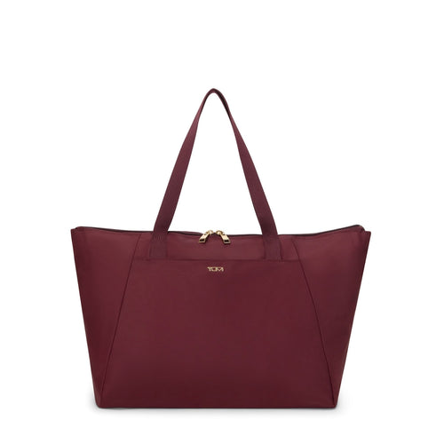 Wine TUMI tote bag with gold zipper on a white background