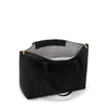 Black TUMI tote bag with gold zipper on a white background