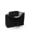 Black TUMI handbag with gold zippers on a white background
