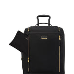 Black TUMI suitcase with gold accents on a white background