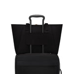 Black TUMI suitcase with handle and wheels on a white background