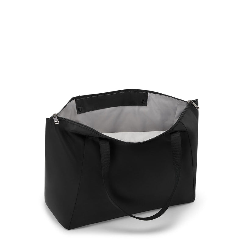 Black TUMI tote bag with a gray interior on a white background