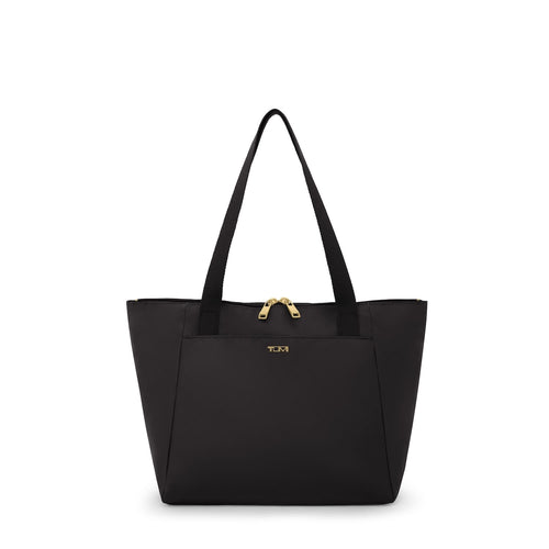 Black TUMI tote bag with gold zipper on a white background