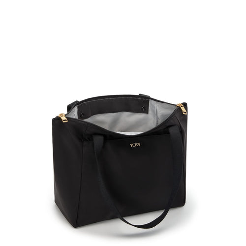 Black TUMI tote bag with gold accents on a white background
