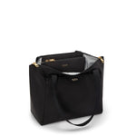 Black TUMI tote bag with gold accents on a white background