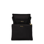 black TUMI pouch with gold zippers on a white background