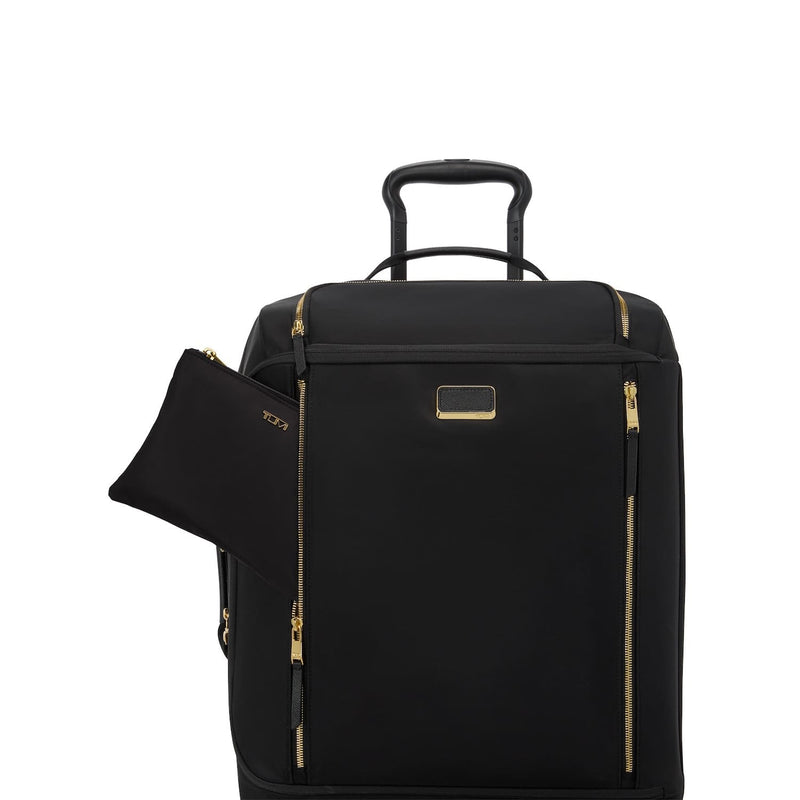 Black TUMI suitcase with gold zippers and handle on a white background