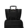 Black TUMI tote bag and black suitcase stacked on a white background