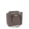 Mink TUMI handbag with a visible brand logo on a white background