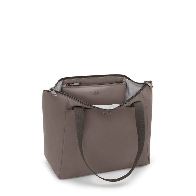 Mink TUMI handbag with a visible brand logo on a white background