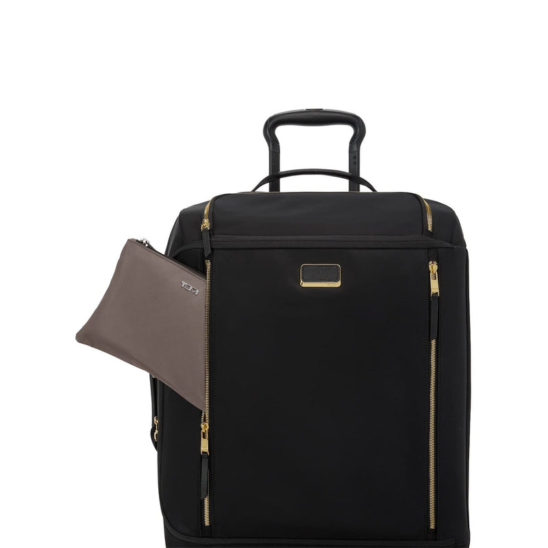 Black TUMI suitcase with gold accents and a matching pouch on a white background
