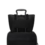 Two black TUMI bags stacked on a white background