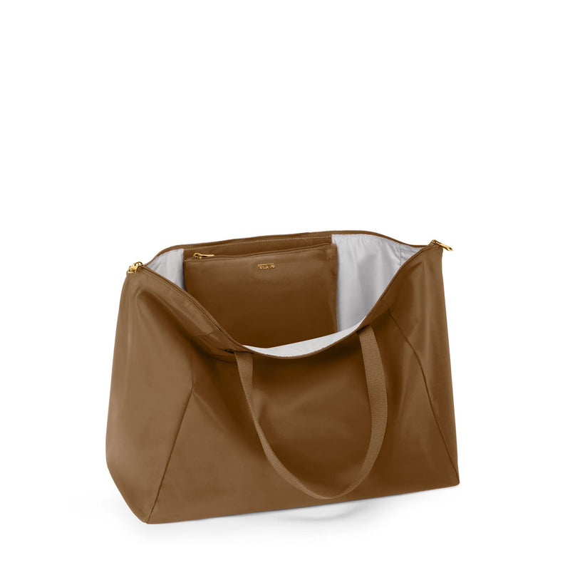 Copper TUMI tote bag with a white interior on a white background